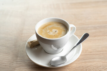 Cappuccino coffee in a white cup on the table, top view. favorite cup of coffee concept.
