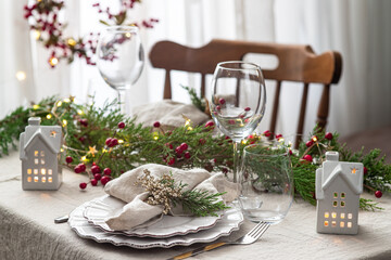 Stylish table setting with candles and Christmas decorations
