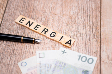 Inscription energia next to polish money. Concept showing rising inflation and energy prices in...