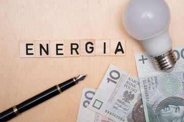 Inscription energia next to polish money. Concept showing rising inflation and energy prices in...