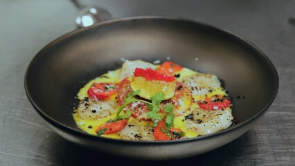 The chef is preparing a sweet dish. Sweet dessert from the chef. A dish of vegetables and fruits. Commercial kitchen. Cooking a signature dessert from the chef