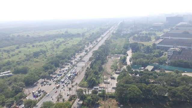Traffic movement on eastern express highway besides Godrej Housing colony at Vikhroli near the creek side. Shot from an high rise building inside Godrej industrial campus