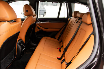 Modern SUV car inside. Leather light back passenger seats in modern luxury car. Comfortable leather seats.