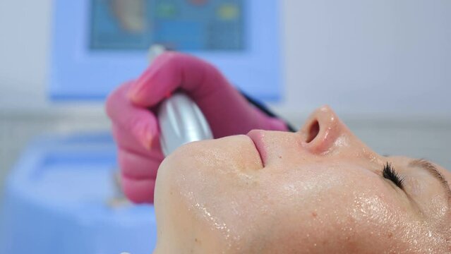 Rf lifting skin tightening in modern beauty clinic. Female patient getting anti-age procedure in spa salon. Hardware cosmetology. Beautician making rf lifting treatment. Rejuvenating skin, preventing