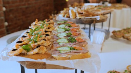 Catering. Table in a restaurant with appetizers at an event. Wedding buffet with fish and meat appetizers. Buffet with cold appetizers. Breakfast buffet at the hotel