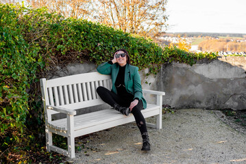 Fototapeta premium girl sitting on a bench with glasses