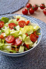 Fresh vegetable salad with lettuce, tomato, cucumber, red pepper and chives