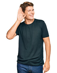Handsome caucasian man wearing casual clothes smiling with hand over ear listening an hearing to rumor or gossip. deafness concept.