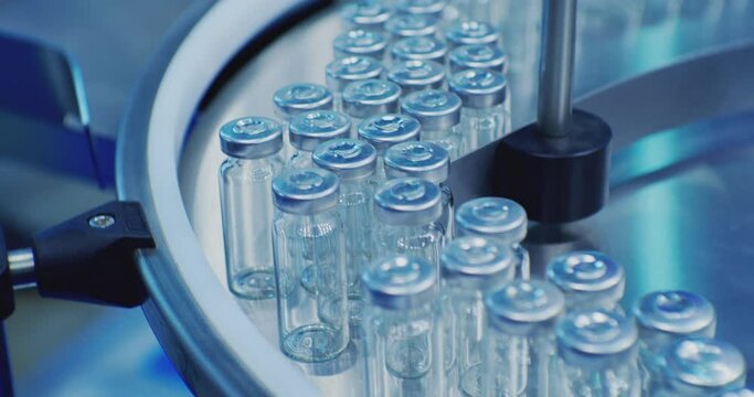 pharmaceutical industry.modern industrial equipment.a lot of glass vials are moving along the production line.close-up.