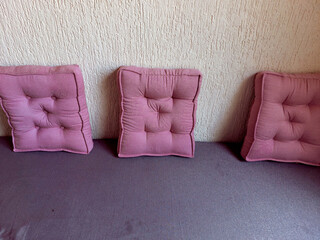 pink pillows kept on blue couch, still objects