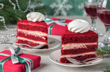 Two servings of Red Velvet cake, wine and gifts on a gray background, dessert for the New Year