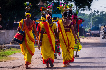 Black tribal women are going to celebrate their religious program  in their traditional costume.