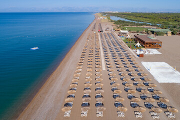 Obraz premium Sandy beaches of the Mediterranean. Kundu - Belek holiday complex with five star hotels. Beach, sea, water sports, parasailing, entertainment and shopping center Aerial view. Antalya, Turkey