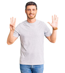Handsome young man with bear wearing casual tshirt showing and pointing up with fingers number eight while smiling confident and happy.