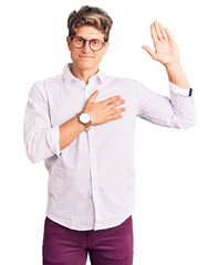 Young handsome man wearing business clothes and glasses swearing with hand on chest and open palm,...