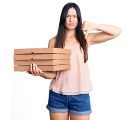 Young beautiful caucasian woman holding delivery pizza box with angry face, negative sign showing dislike with thumbs down, rejection concept