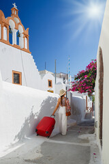 Young woman travels around the island of Santorini