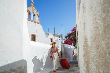 Young woman travels around the island of Santorini
