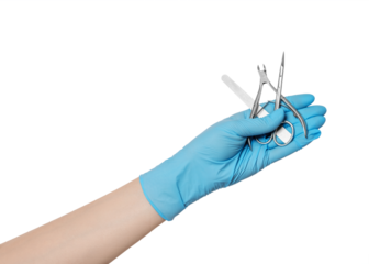 A set of manicure tools in hand with glove: scissors, cuticle removal tool, nailfile.