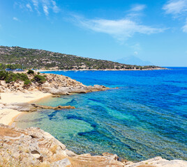 Summer sea scenery with aquamarine transparent water and sandy beaches. View from shore (Sithonia, Halkidiki, Greece).