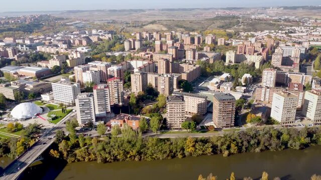 Aerial perspective of Valladolid city. Situated in Spain, in Castilla y Leon Province. View of River Pisuerga and La Rosaleda Park. Beautiful panorama of whole city. Drone forward and panning right