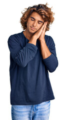 Young hispanic man wearing casual clothes sleeping tired dreaming and posing with hands together while smiling with closed eyes.