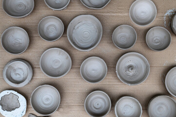 Top view at background of air drying handmade clay bowls.