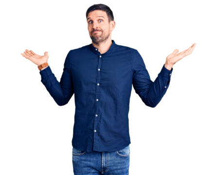 Young handsome man wearing casual shirt clueless and confused expression with arms and hands raised. doubt concept.