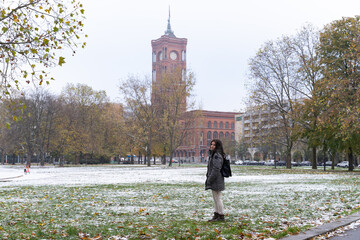 Young female tourist with the Rotes Rathaus in the background and snowy surroundings