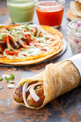 Chicken Seekh Kebab paratha roll kathi shawarma wrap with dipping sauce isolated on background side...