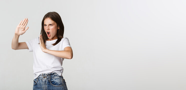 Sassy Young Woman Standing In Fighting Pose To Protect Herself From Attack