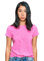 Fototapeta premium Beautiful asian young woman wearing casual pink t shirt depressed and worry for distress, crying angry and afraid. sad expression.