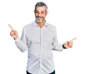 Middle age hispanic with grey hair wearing casual white shirt smiling confident pointing with fingers to different directions. copy space for advertisement
