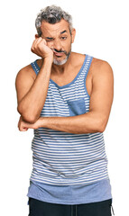 Middle age grey-haired man wearing casual style with sleeveless shirt thinking looking tired and bored with depression problems with crossed arms.