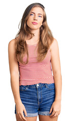 Beautiful caucasian young woman wearing casual clothes relaxed with serious expression on face. simple and natural looking at the camera.