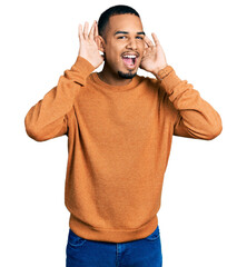 Young african american man wearing casual clothes smiling cheerful playing peek a boo with hands showing face. surprised and exited