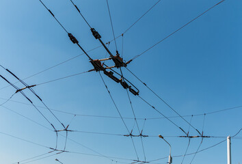Trolleybus wires against the blue sky. Designed for the transmission of electricity from traction substations to the electric rolling stock of the trolleybus.