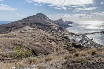 aerial of barren slopes and thermolelectric plant near harbor, Porto Santo