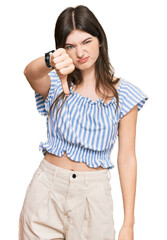 Young beautiful caucasian girl wearing casual clothes looking unhappy and angry showing rejection and negative with thumbs down gesture. bad expression.