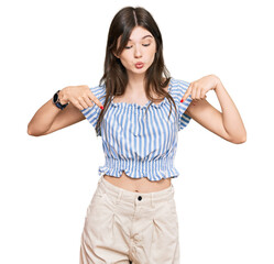 Fototapeta premium Young beautiful caucasian girl wearing casual clothes pointing down with fingers showing advertisement, surprised face and open mouth