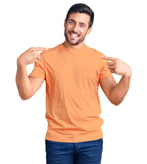 Young hispanic man wearing casual clothes looking confident with smile on face, pointing oneself with fingers proud and happy.