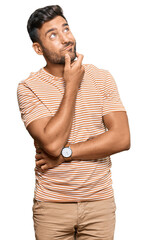 Handsome hispanic man wearing casual clothes thinking worried about a question, concerned and...