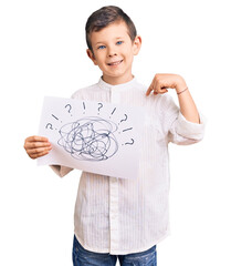 Cute blond kid holding scribble draw pointing finger to one self smiling happy and proud