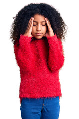 African american child with curly hair wearing casual winter sweater suffering from headache desperate and stressed because pain and migraine. hands on head.