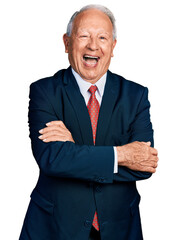 Senior business man with grey hair with arms crossed gesture smiling and laughing hard out loud because funny crazy joke.