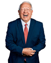 Senior man with grey hair wearing business suit and glasses smiling and laughing hard out loud...