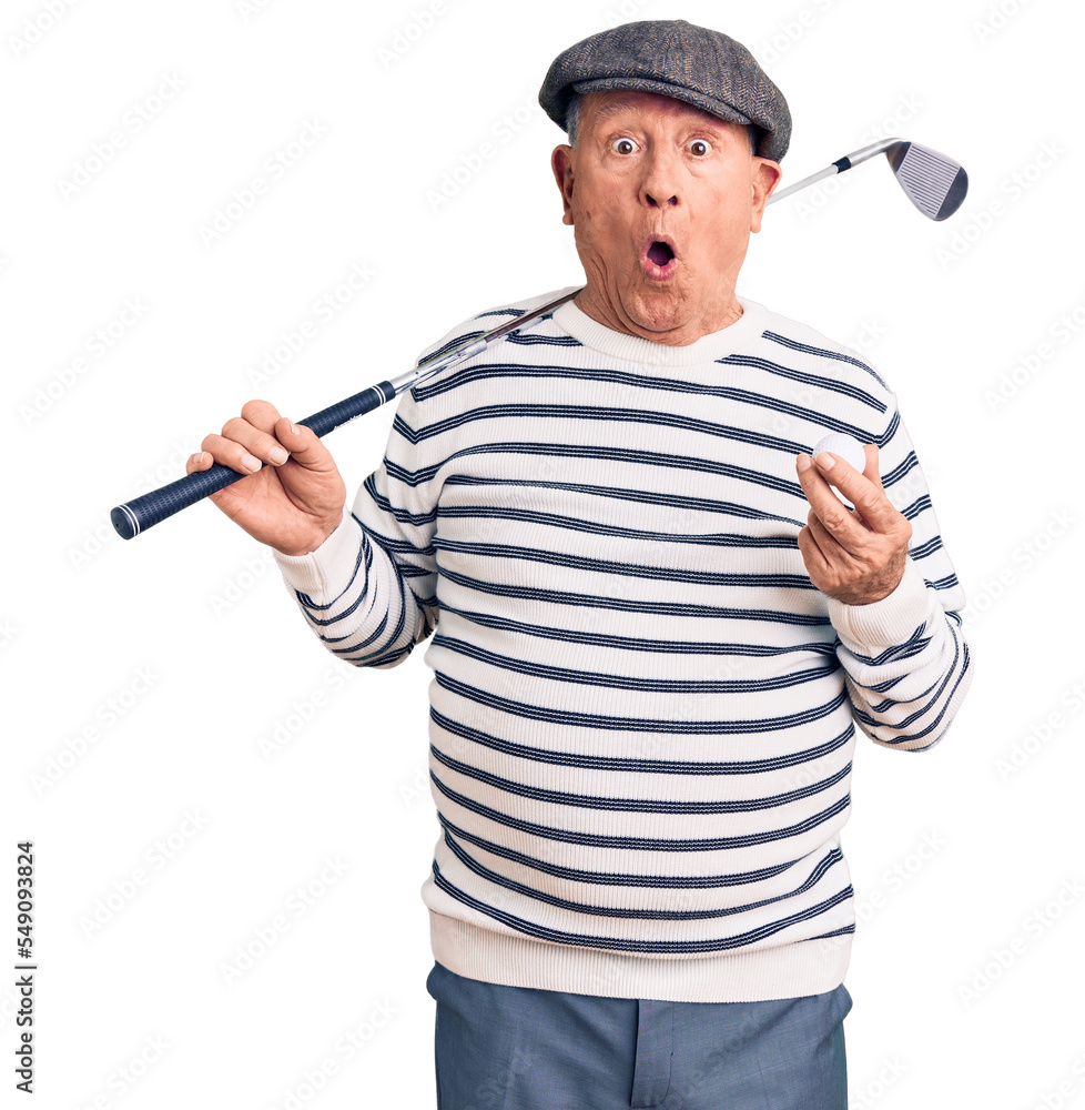 Poster senior handsome grey-haired man holding golf club and ball scared and amazed with open mouth for sur