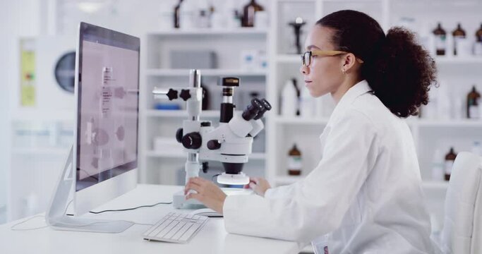 Microscope, computer and science black woman typing results, data and research for medical innovation, investigation and bacteria test. Software scientist writing biotechnology report in a laboratory