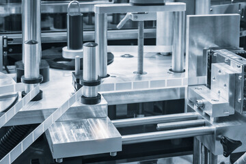 Fragment of the conveyor of sticking labeling machine. Abstract industrial background.