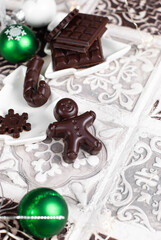 Homemade dark chocolate, Christmas praline gingerbread man, chocolate bar, snowflake, candy cane.